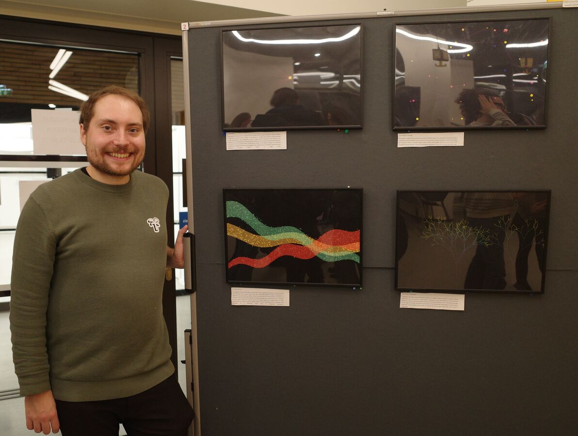 Gilles Colling standing next to the four exhibited artworks at the VDSEE Art and Science exhibition